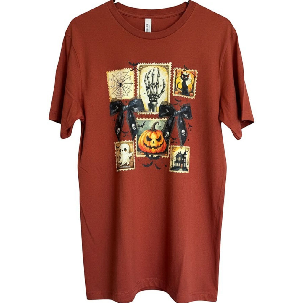 Zia Rose Boutique rust orange cotton t-shirt featuring black lace bows and vintage-style Halloween stamp graphics.