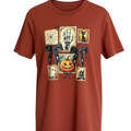 Zia Rose Boutique rust orange cotton t-shirt featuring a graphic print of Halloween stamps and black lace bows.