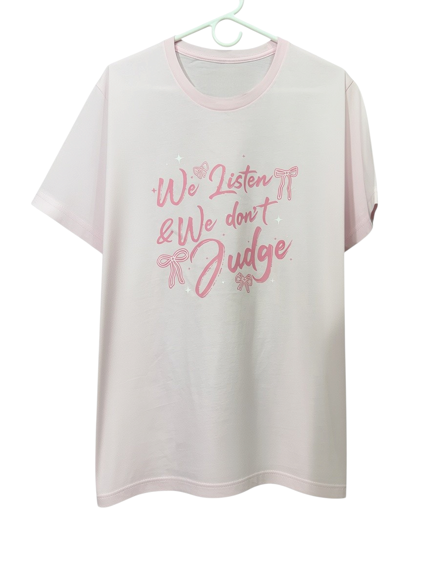 Zia Rose Boutique light pink t-shirt featuring We Listen We Dont Judge text and pink bow graphics
