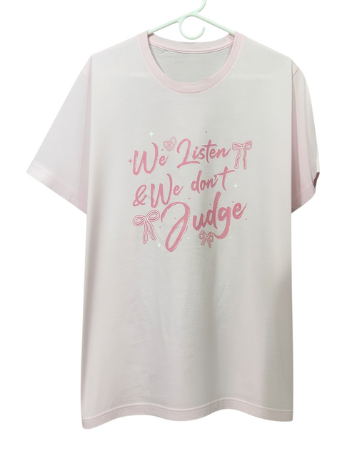 Zia Rose Boutique light pink t-shirt featuring We Listen We Dont Judge text and pink bow graphics